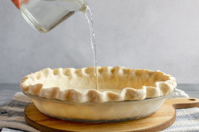 adding the water into the pie crust for water pie
