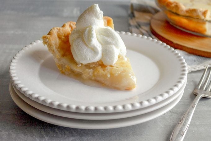 slice of water pie on a plate with whipped cream