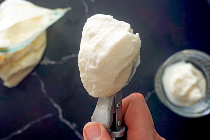 close up of a scoop of fresh coffee creamer ice cream over dark marble background