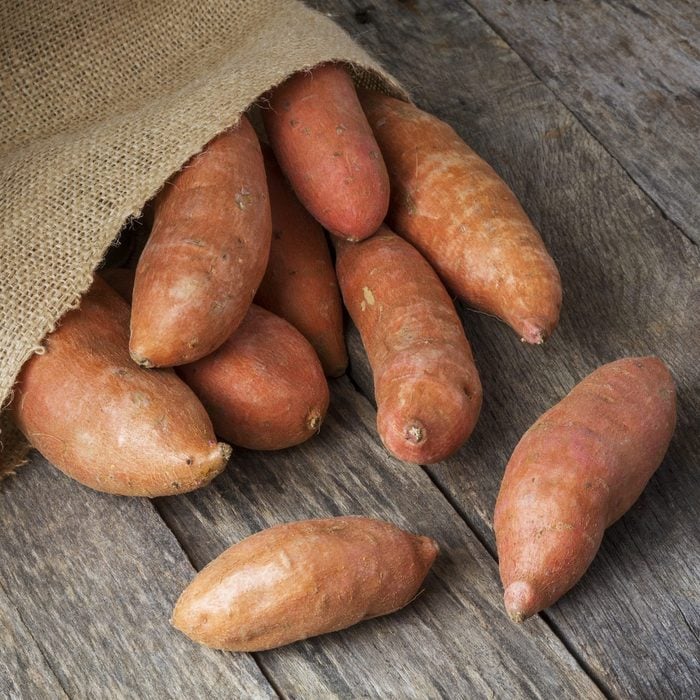 Sweet Potatoes Spilling From Burlap Bag