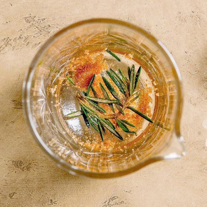 top view of a glass with muddled sugar and rosemary