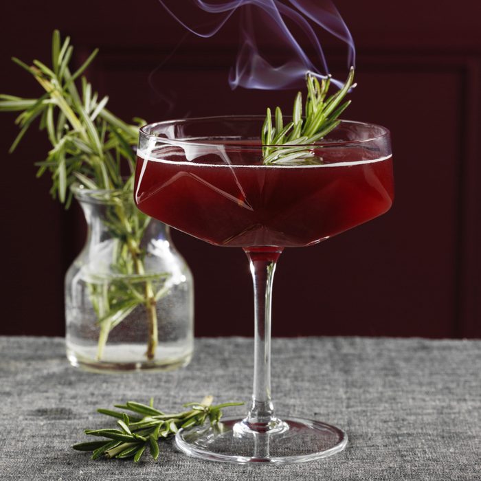 Cocktail Garnished With Smoking Rosemary Sprig