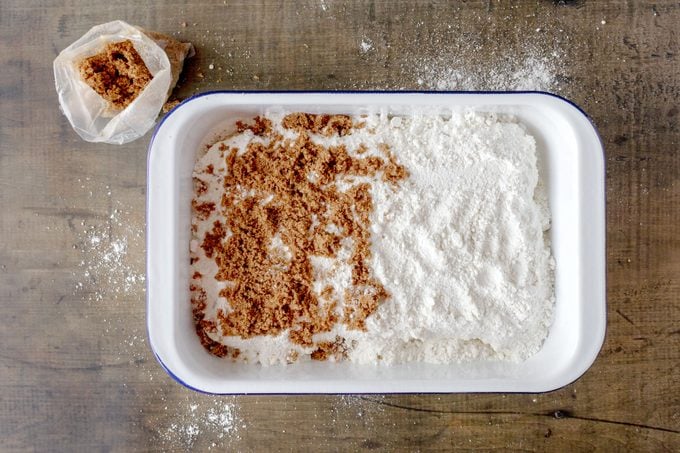 cake mix and brown sugar added to the pan filled with cinnamon dump cake before baking