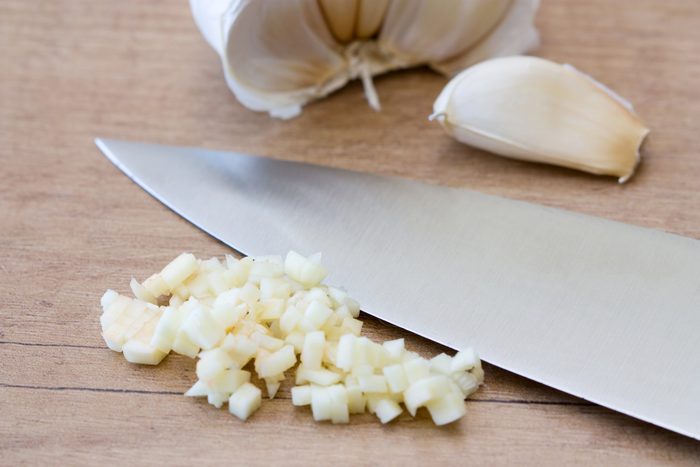 Freshly chopped garlic next to knife