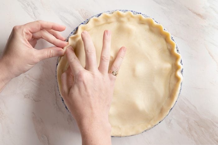 putting the crust on top of the pie