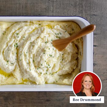 a baking pan with mashed potatoes and a wooden spoon, a circular photo of ree Drummond in the bottom right corner