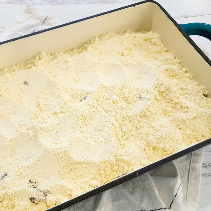 cake mix powder in a pan for making Caramel Apple Dump Cake