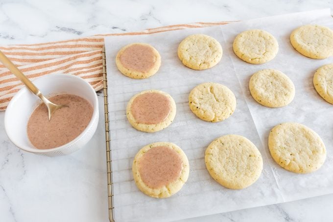 Taylor Swift Chai Cookies on a cooling rack, three Cookie are frosted and the others are not