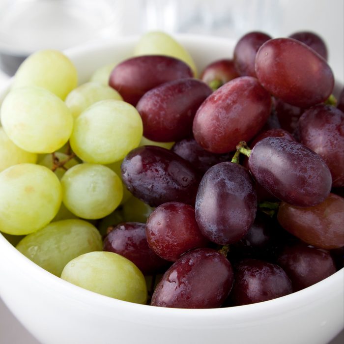 green and red Grapes In A white bowl