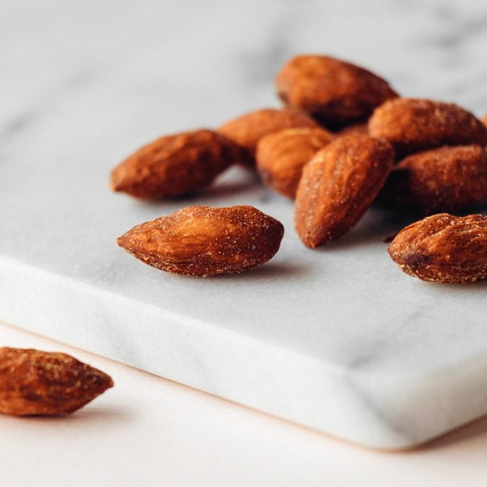 Salted and roasted almonds on a marble background