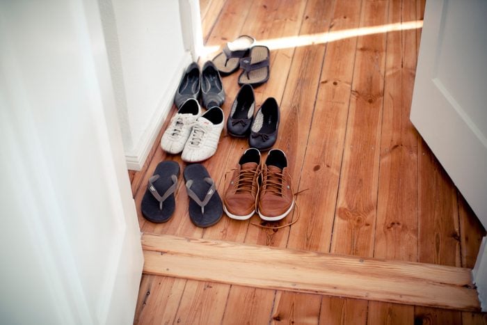 Various shoes in hallway after the guests took them off before coming in to the house