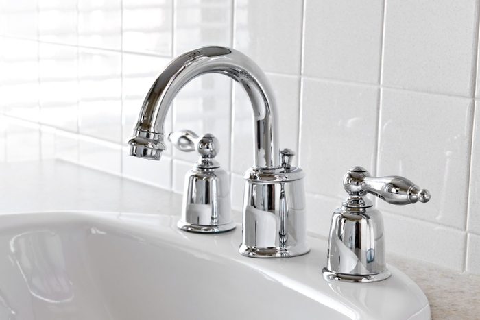 white bathroom vanity with chrome faucet