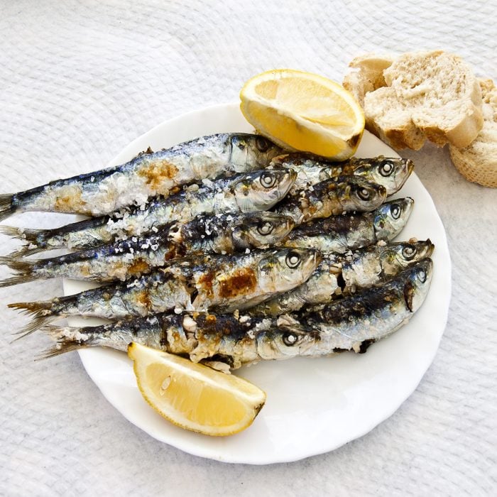 Sardines on a plate with Lemond wedges on the side