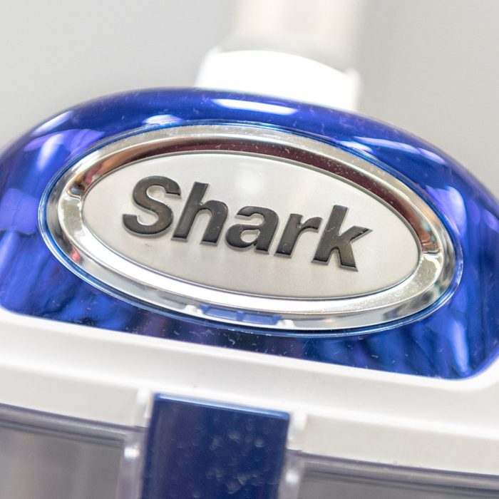 A blue and white Shark Vacuum on a store display.
