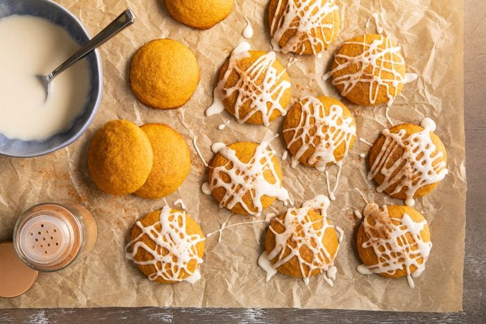 Gluten Free Pumpkin Cookies being drizzled with glaze