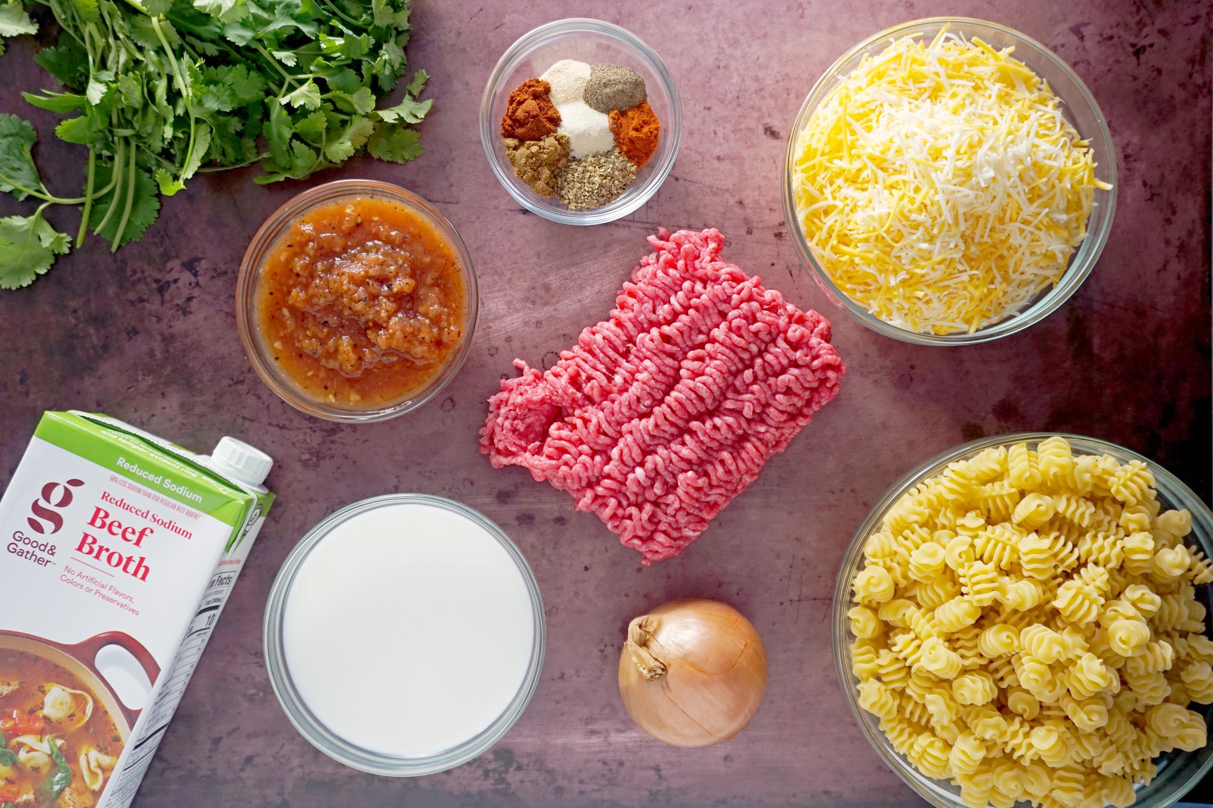 ingredients for cheesy taco pasta on a kitchen counter