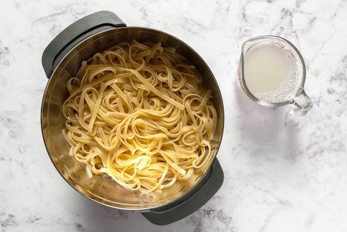 cooked pasta in a pot on a marble counter