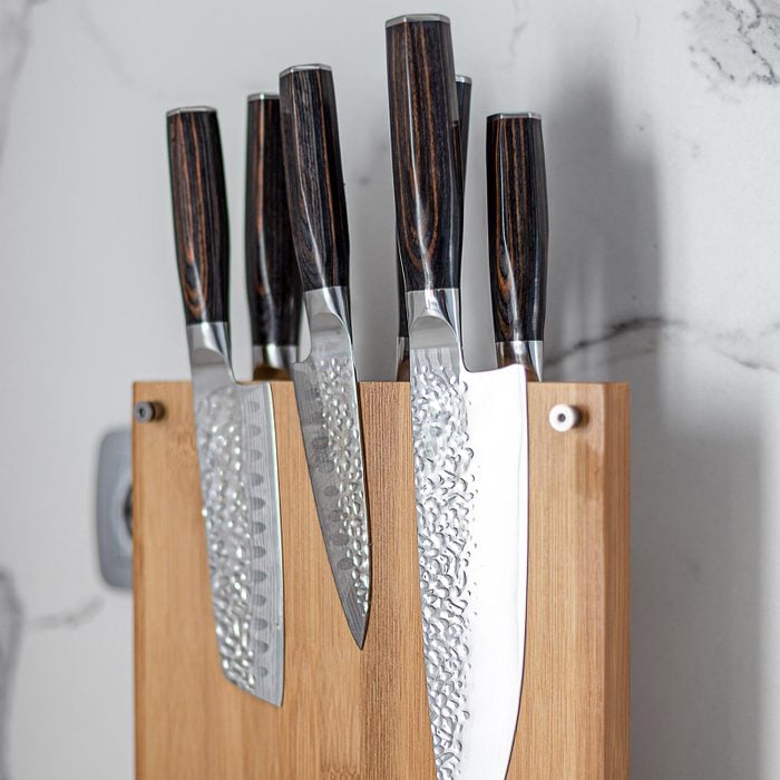 Damascus Kitchen Knife Block Set on a wooden magnetic holder with white marble background
