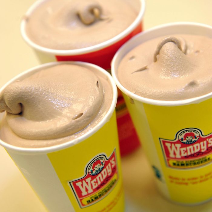 Wendy's Frosty with 3 chocolate grouped together on a beige background