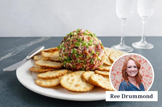 a plate of crackers with the pioneer woman cheese ball and a portrait of ree Drummond