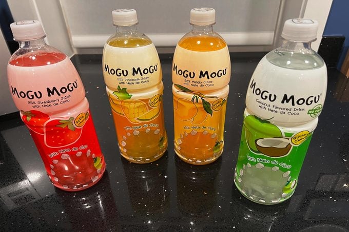 Mogu Mogu Bottles on a black countertop and white background