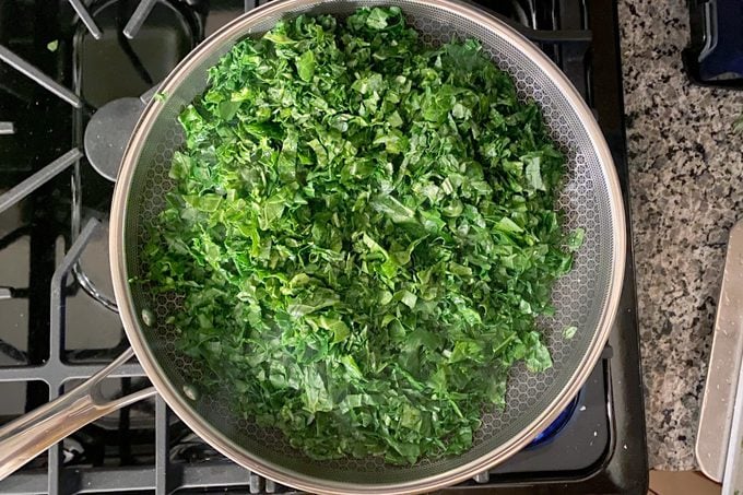 greens cooking in a HexClad pan
