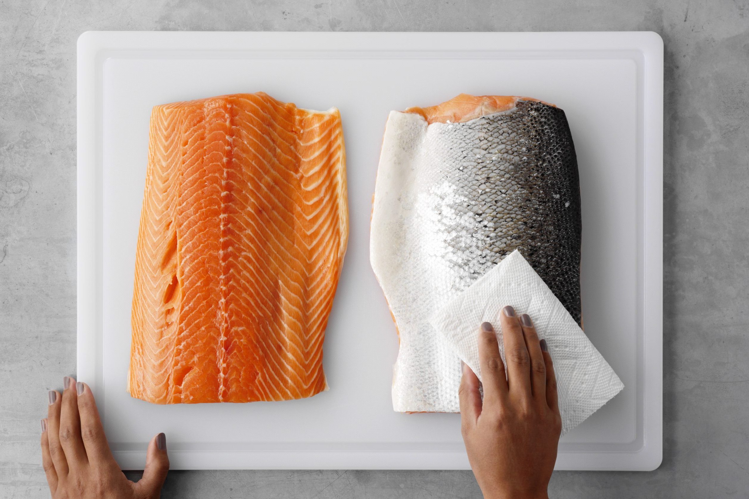 featured image for how to remove salmon skin; skin-on salmon on cutting board