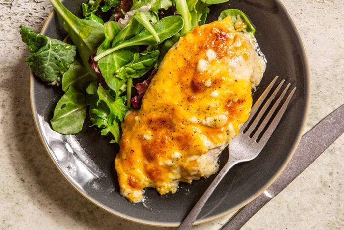 cheesy ranch chicken in a bowl with a side salad