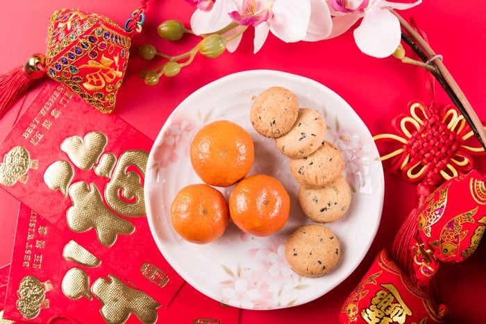 cookies and red envelopes on the red background