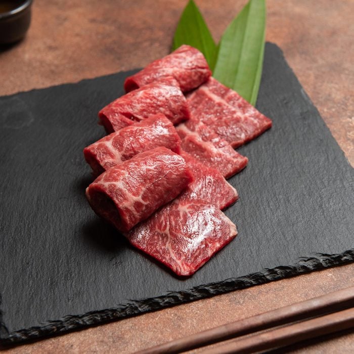 Raw Wagyu Beef Brisket Slice Set On Black Marble Dish Rock.