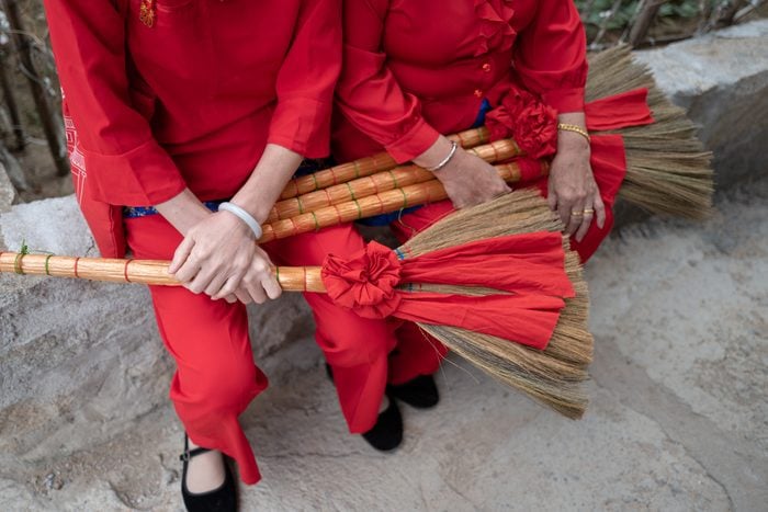 Female worshipers of Mazu holding broomsticks used in religious parades