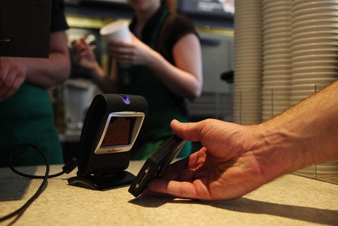 Starbucks customer uses iPhone app to pay for a coffee at a store in Los Angeles