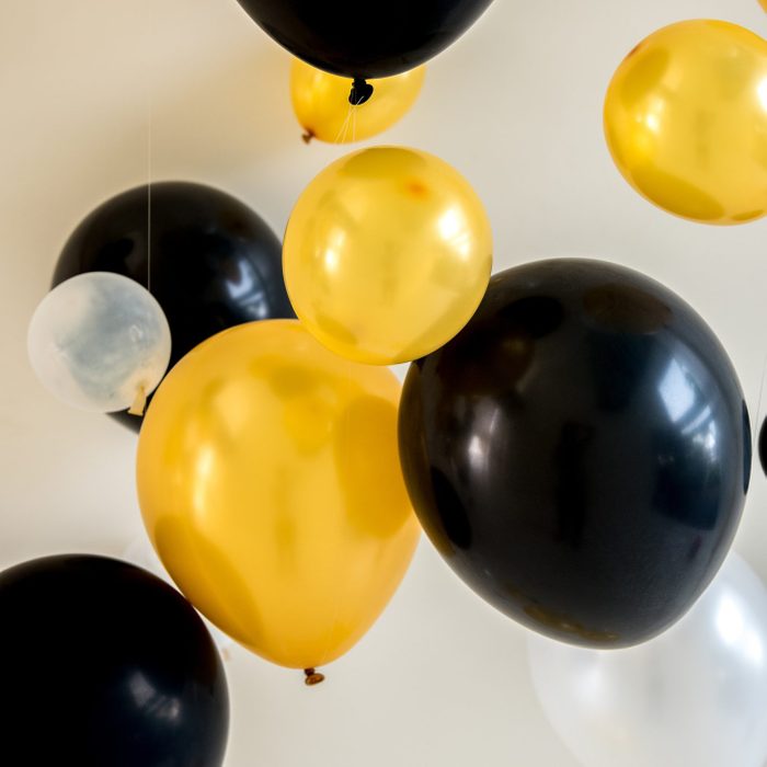 balloons yellow and black color on backdrop