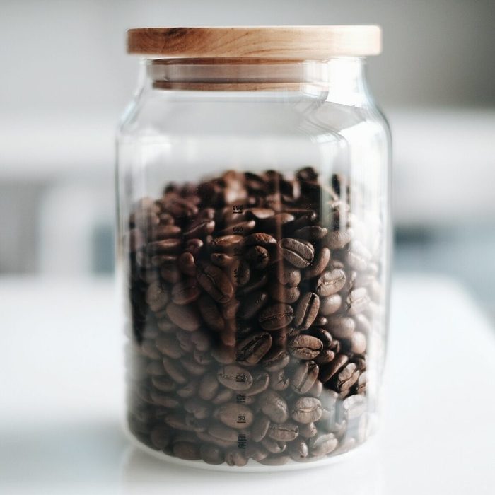 Close-Up Of Roasted Coffee Beans In Jar On Table