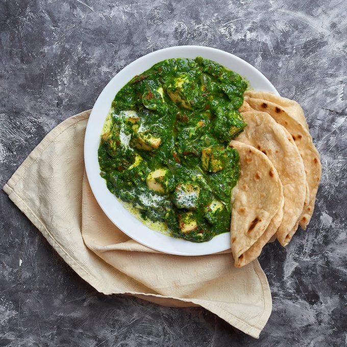 Palak Paneer with chapati at grey concrete background. Palak paneer or green paneer - is the indian cuisine vegetarian dish mades of spinach and paneer cheese.