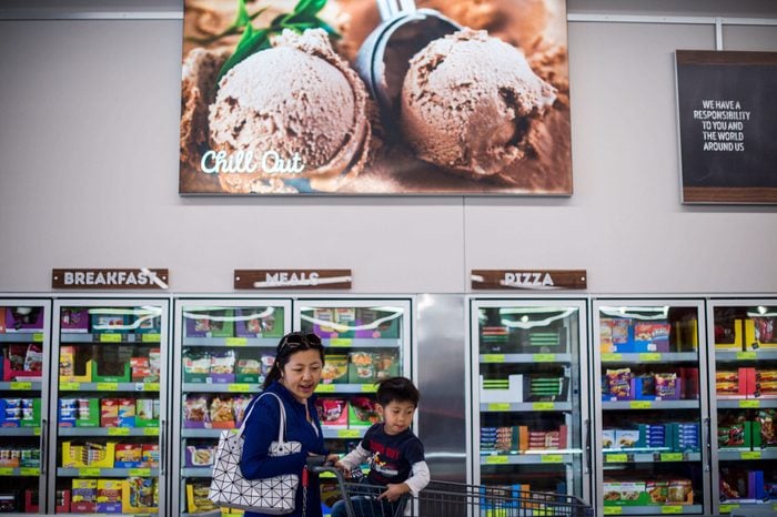mother and son shopping in Aldi frozen section