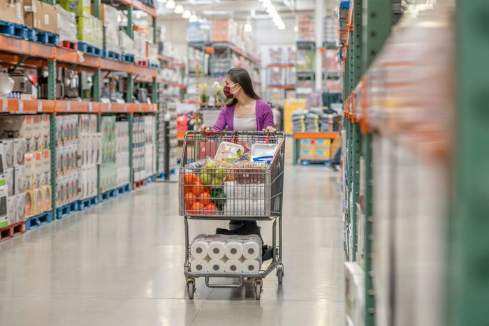 Asian Woman Pushing Her Shopping Cart