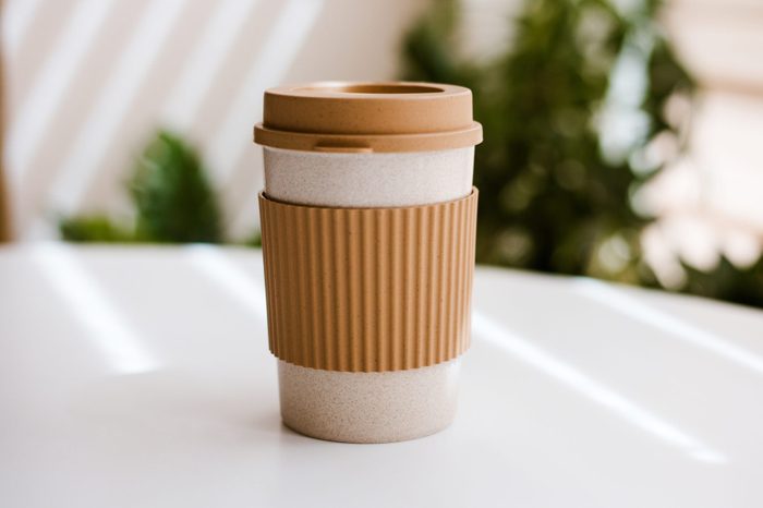 Eco-friendly cup for hot drinks on white table with space for text