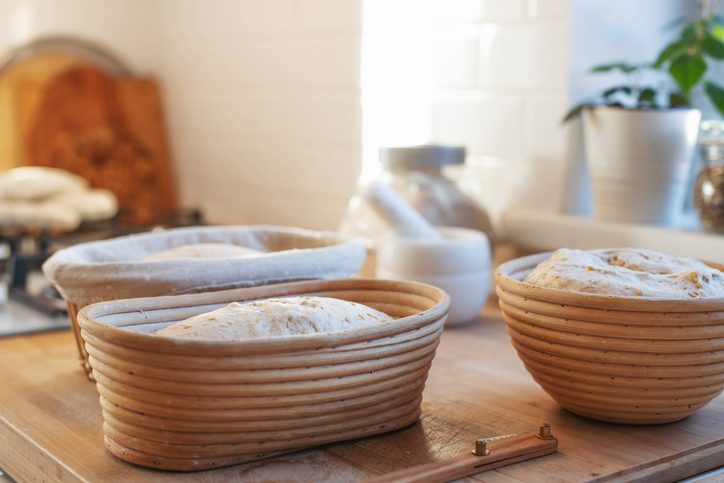 Preparations of sourdough Bread in banneton baskets on the table 