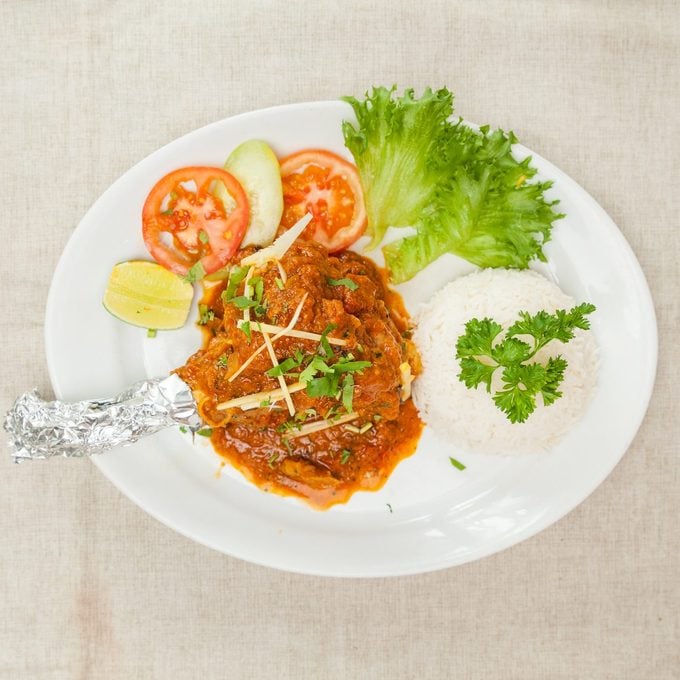 Mutton Raan masala with gravy and salad served in a dish isolated on table top view of indian spices food