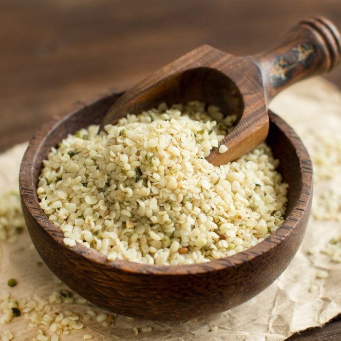 Uncooked Hemp seeds in a bowl with a spoon