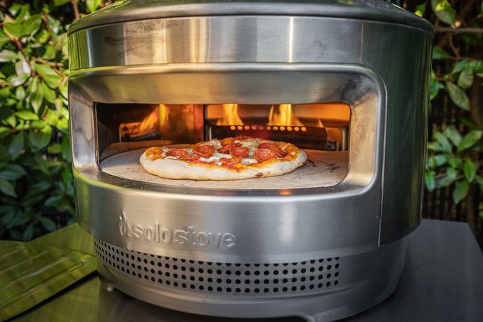 pizza cooking in a solo stove pizza oven