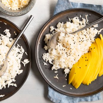 Coconut Rice with mango slices on black plates