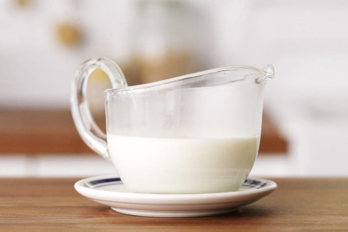 white sauce in a clear gravy boat
