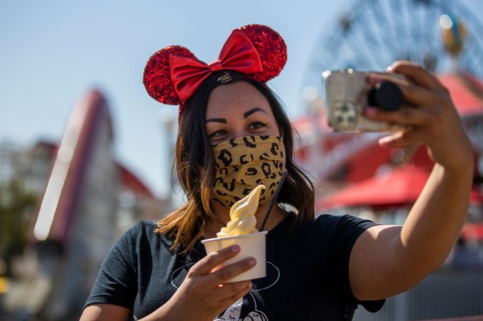 Young Lady poses with Disney Dole Whip in the Anaheim Theme Park