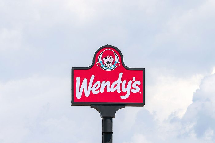 The Wendy's Logo Is Seen Above The Restaurant on a cloudy background