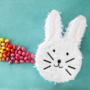 Cheerful easter bunny Piñata with easter eggs