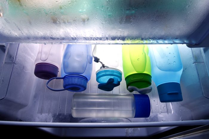 Photo Of Plastic Drink Tumblers Filled With Cold Water In The Chiller Tray Inside A Refrigerator.