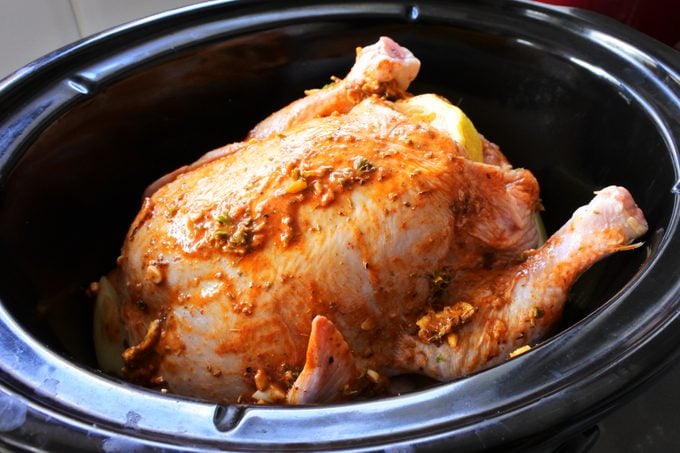 Cooking chicken with herbs in a slow cook