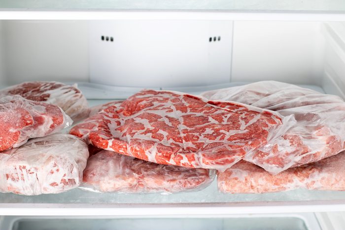 Chicken beef and pork Packed in plastic bags in the white freezer. Frozen raw meat.